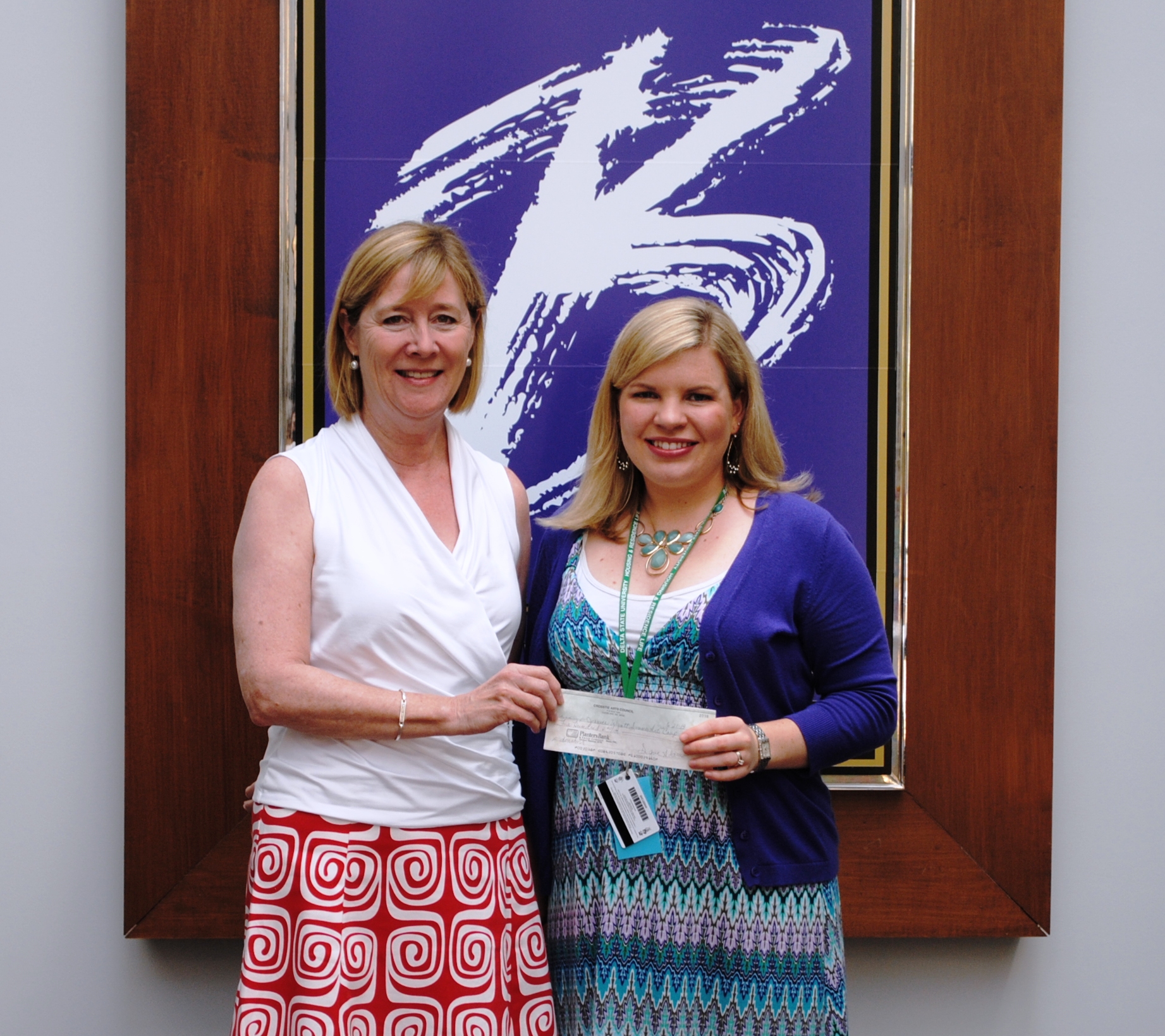 See Attachment Photo Signe Adams, Crosstie Arts Council Treasurer, presents a check for the Janice Wyatt Mississippi Summer Arts Institute to Whitney Cummins, BPAC Arts Education Coordinator.