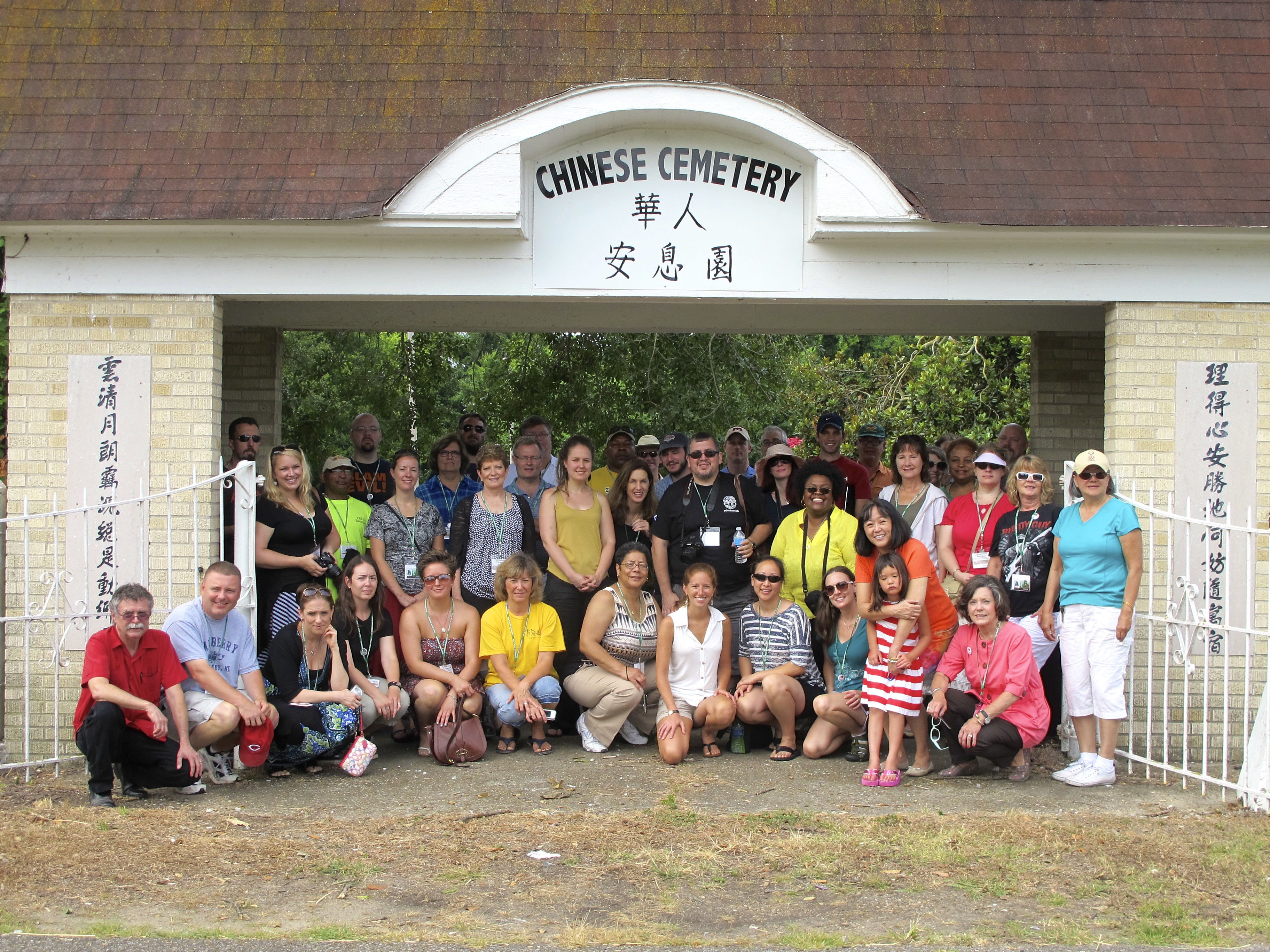 Participants of the workshop standing in front of the “New” Chinese Cemetery in Greenville, where they were introduced to the stories of the Delta Chinese by Cathy Wong. Photo by Rachel Anderson.