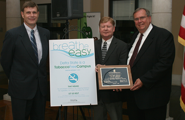 Roy Hart, director of the Office of Tobacco Control at the Mississippi State Department of Health, presents an award recognizing Delta State University as a tobacco-free campus to Delta State Vice President for Student Affairs Dr. Wayne Blansett and Delta State President Dr. John M. Hilpert.   