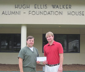 President of the Delta State Bolivar County Alumni Chapter Paul Mancini (left) and Delta State admissions recruiter Chris Gaines in front of the Hugh Ellis Walker Alumni House. 