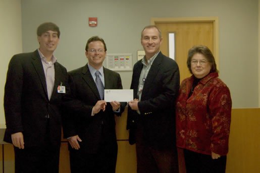 From left to right, Jeffrey Farris, director of Alumni Affairs and John C. Cox, past president of the National Alumni Association Board of Directors, accept the sponsorship check from Wes Sigler, CEO of Bolivar Medical Center and Trena Danna, chairman of the BMC Board of Directors. 