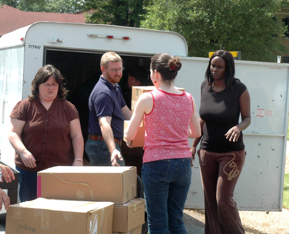 Delta State staff members (l-r) Suzanne Simpson, Eric Atchison, Marcie Behrens, and Letraneshia James load supplies for the victims of the April 27 tornado in Smithville.