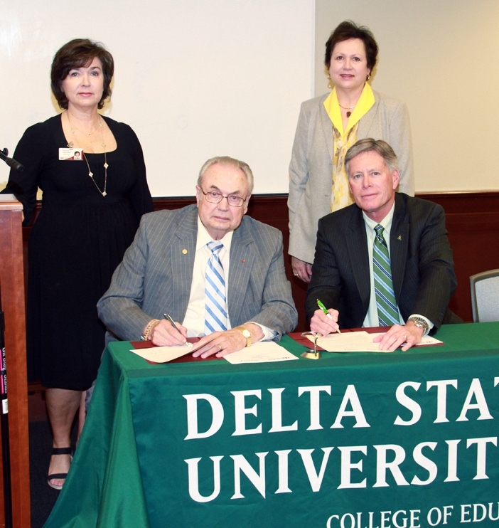 PHOTO:  Seated from left, Hinds Community College President Dr. Clyde Muse, Delta State University President William N. LaForge, standing from left, Vice President for the Hinds Community College Raymond Campus and College Parallel Programs Dr. Theresa Hamilton, and Dean of Delta State’s College of Education and Human Sciences Dr. Leslie Griffin. 
