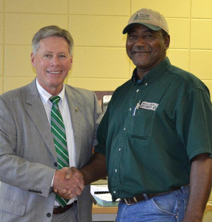 President LaForge shakes employee of the month Michael Kemp’s hand in congratulations.