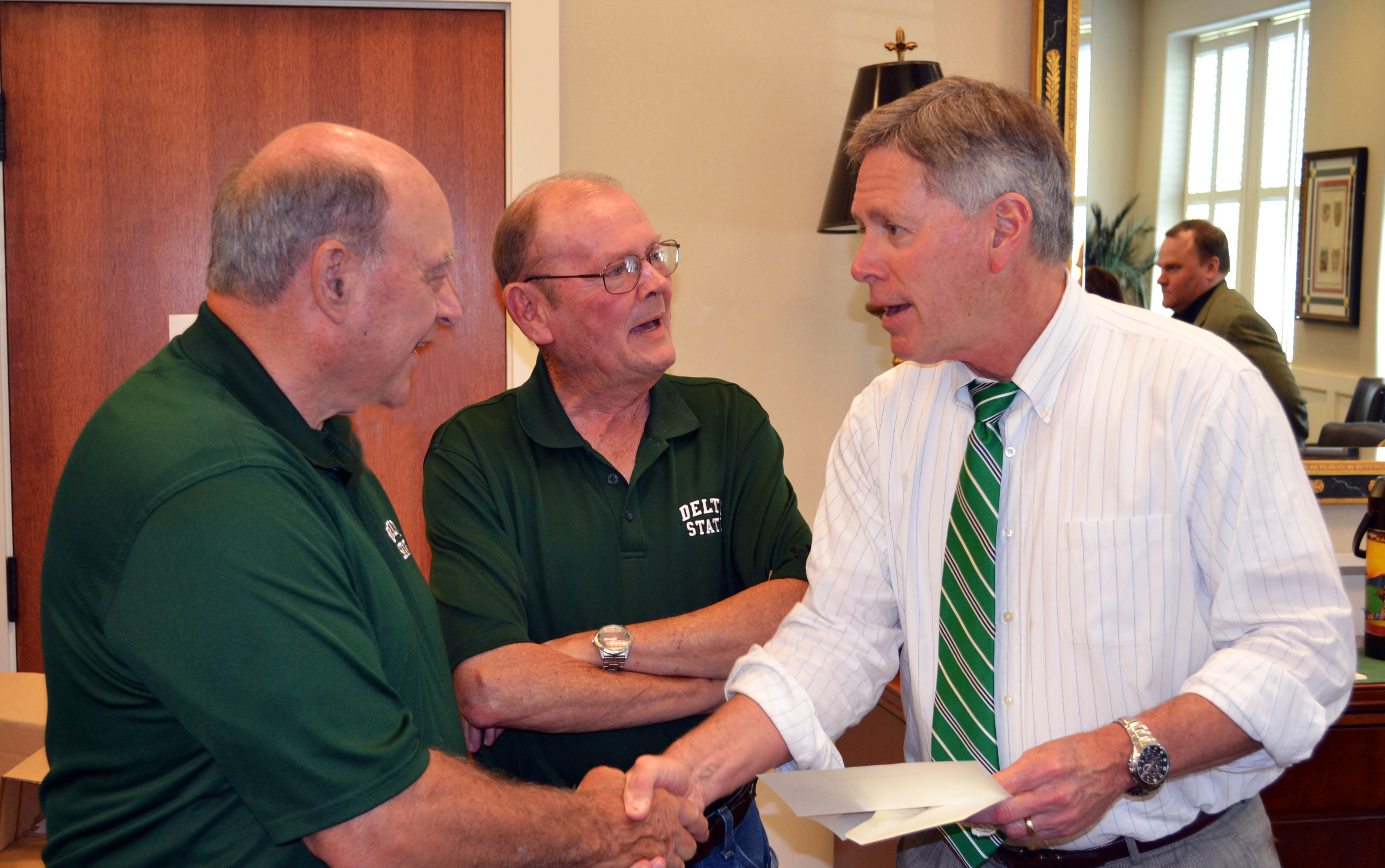 PHOTO:   Charlie McGuffee and James Donald Cooper present a check to Delta State University President William N. LaForge. 