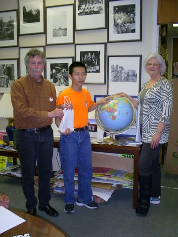 Photo: (L to R) Luther Brown, Director of the DSU Delta Center for Culture and Learning presents Geography student Jun Chen with a sack of "I Love the Mississippi Delta" buttons that he and Pat Kirkpatrick can give to the nation's Geography Bee participants.  Photo by Lee Aylward.