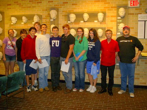 Photo:  The St. Stephens Episcopal School Delta Heritage Class, in front of "A Cast of Blues,"  the collection of life-masks of Blues musicians created by sculptor Sharon McConnell, outside the offices of the Delta Center in Ewing Hall.  Group leader William Southerland is on the far right, next to Luther Brown of the DSU Delta Center.  Photo by Lee Aylward.