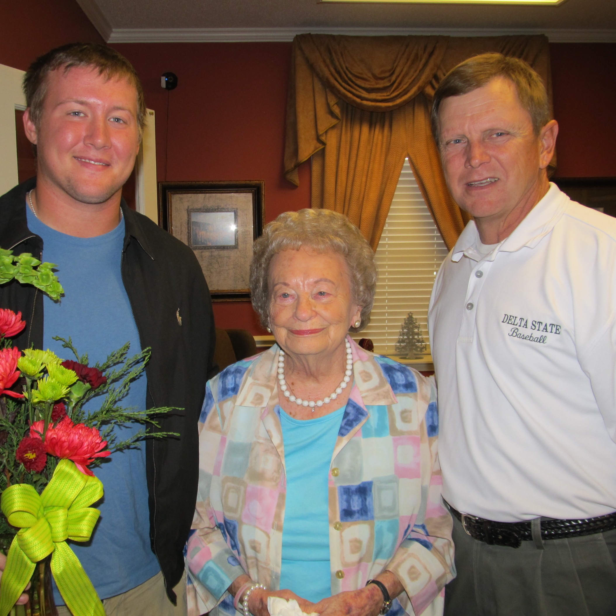 Photo 1:   From left, Brent Langston, recipient of the Doug Schooler Memorial Baseball Scholarship, Mrs. Anna Schooler, mother of Doug Schooler, Coach Mike Kinnison