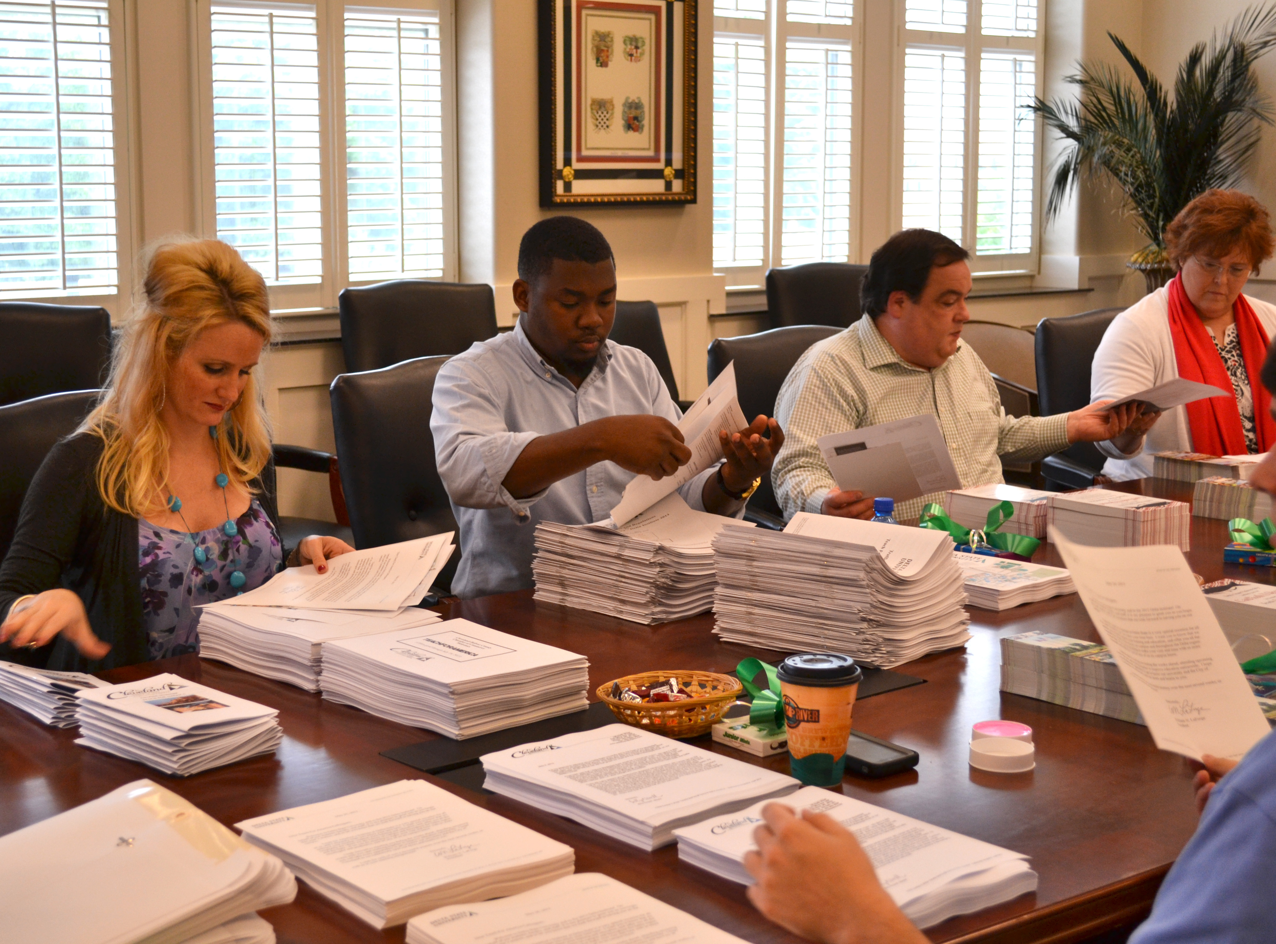 Volunteers prepare welcome packets for incoming TFA guests. 