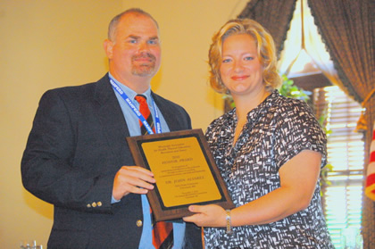 Dr. John G. Alvarez (left) is presented the 2010 Honor Award by MAHPERD President Karin Halverson. 