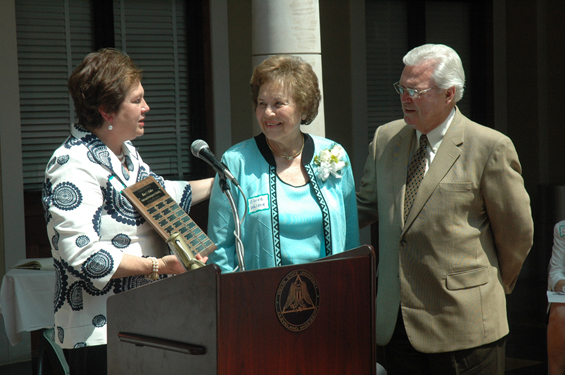 Delta State’s Dean of the College of Education Dr. Leslie Griffin (left) and Dean Emeritus Dr. E. E. “Butch” Caston (right) present Eloise Walker with the plaque that will hang in Ewing Hall recognizing the recipients of the annual scholarship bearing her name.  