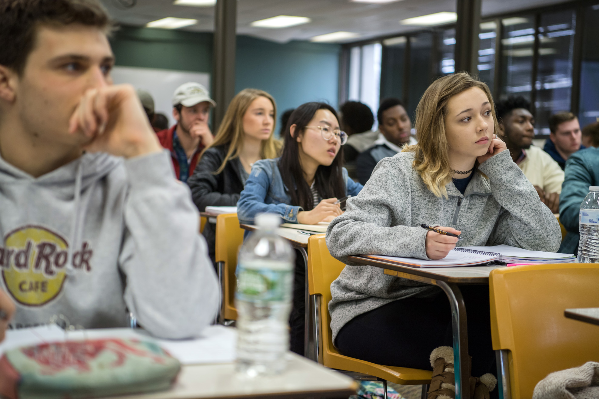 Students engaged and taking notes in lecture course.