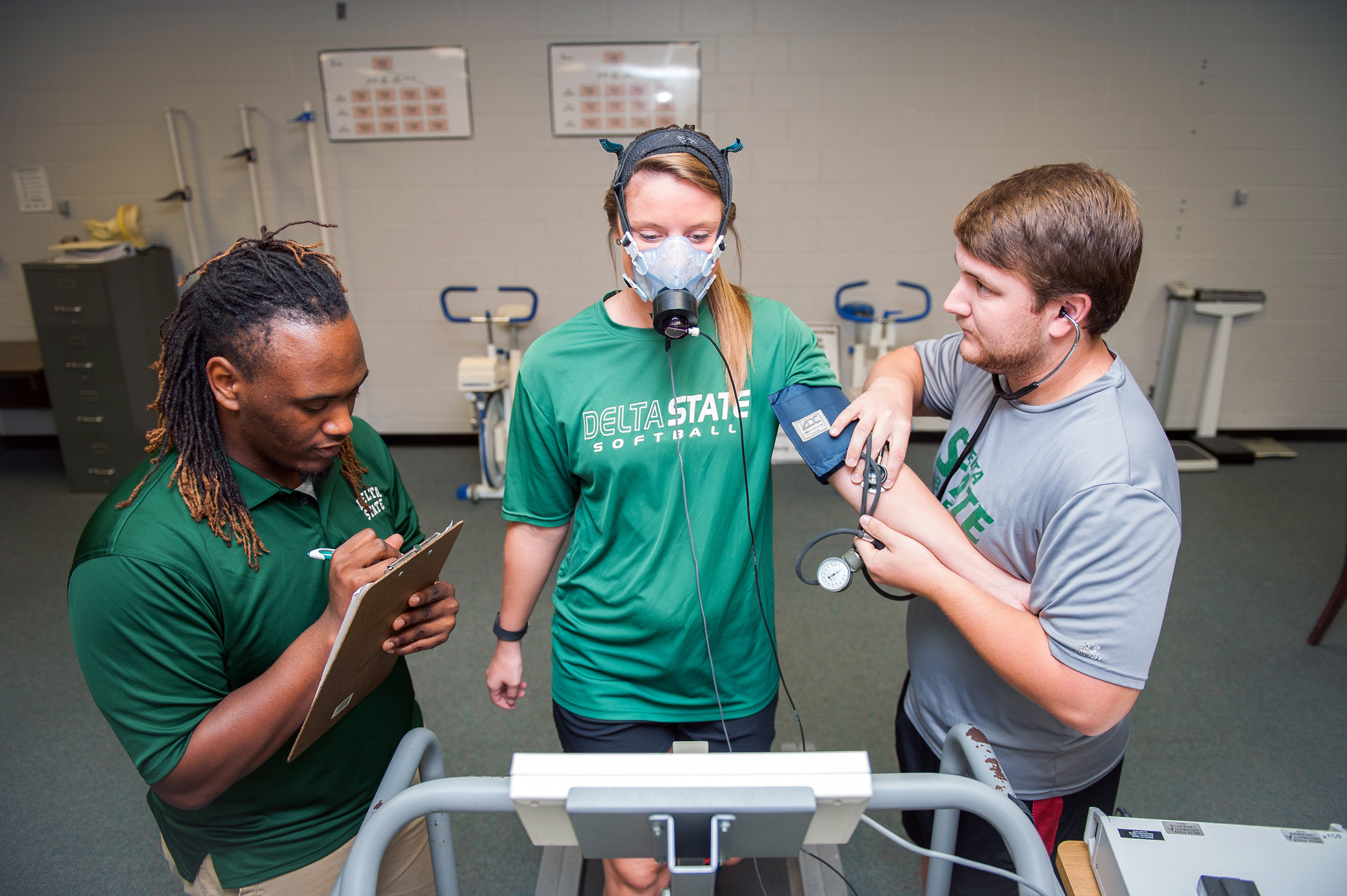 3 students participating in sport and human performance activity.