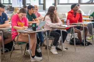Students in a psychology classroom lecture setting.