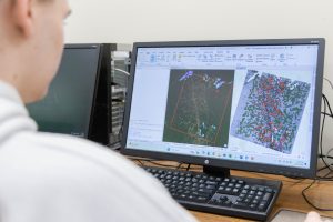 A computer screening showing satellite and aerial imagery that has been processed for interpretation in ArcGIS software.
