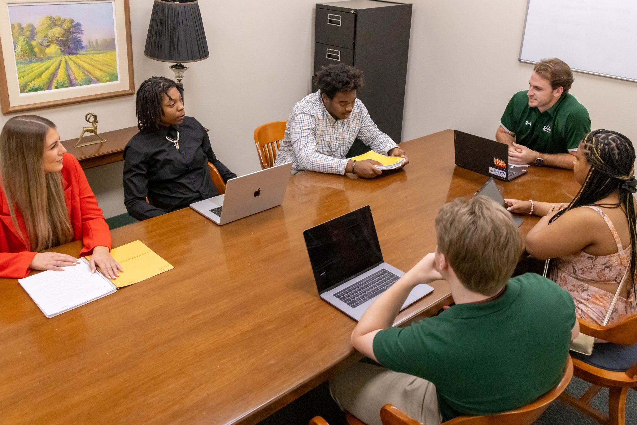 Students collaborating around a table in a group meeting space.