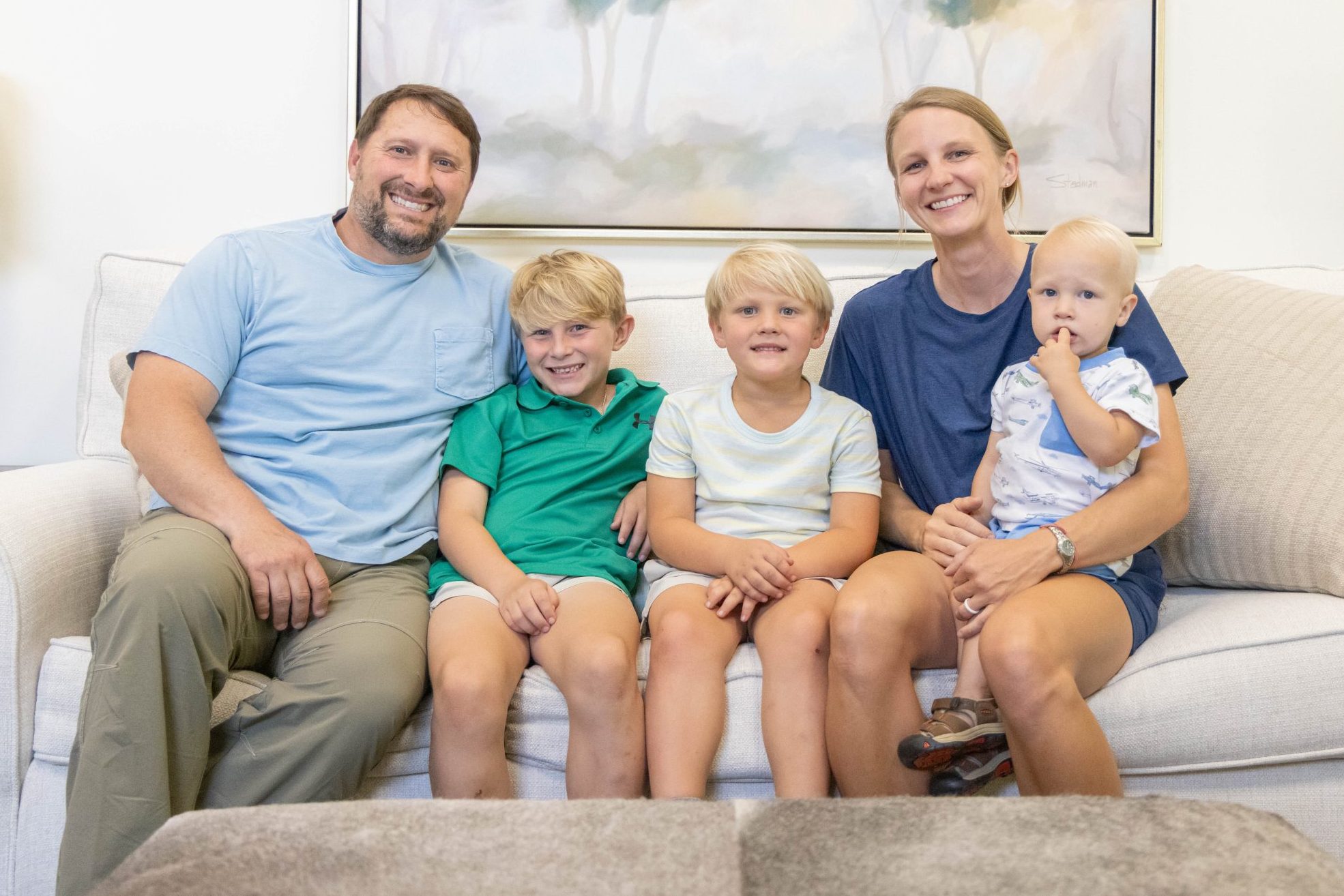 Family sitting together on a couch at home.