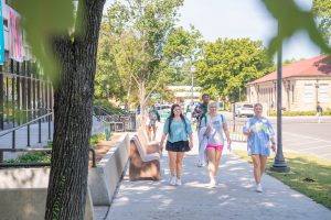 Students walking to class with backpacks.