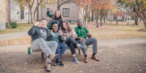 Transfer students hanging out on campus in Delta State gear.