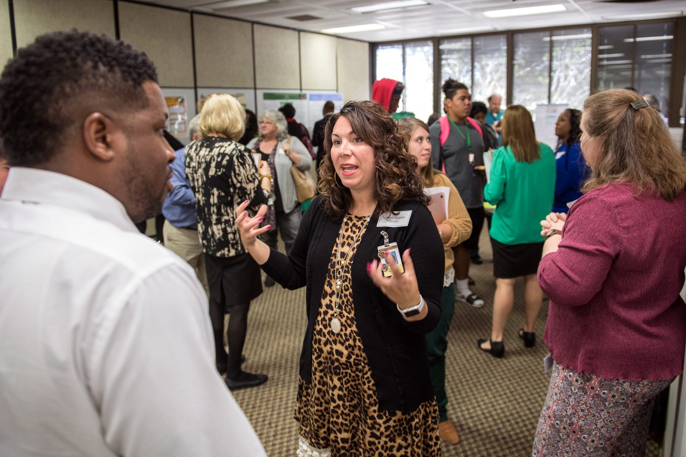 Graduate Student presenting research at research exposition.