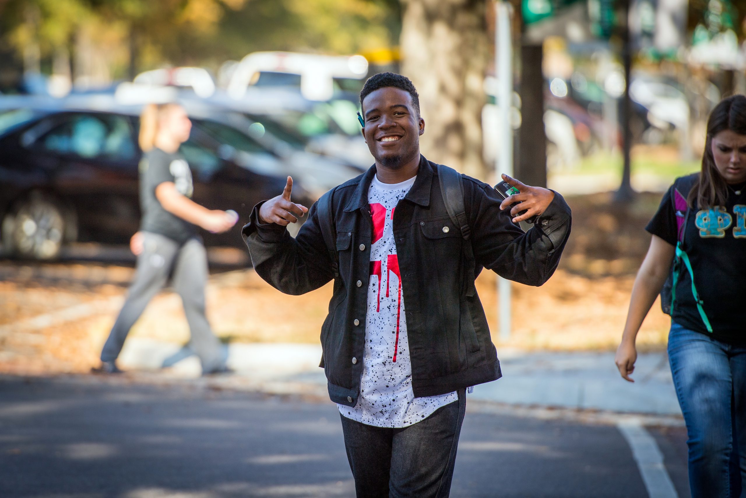 Student smiling and walking to class.