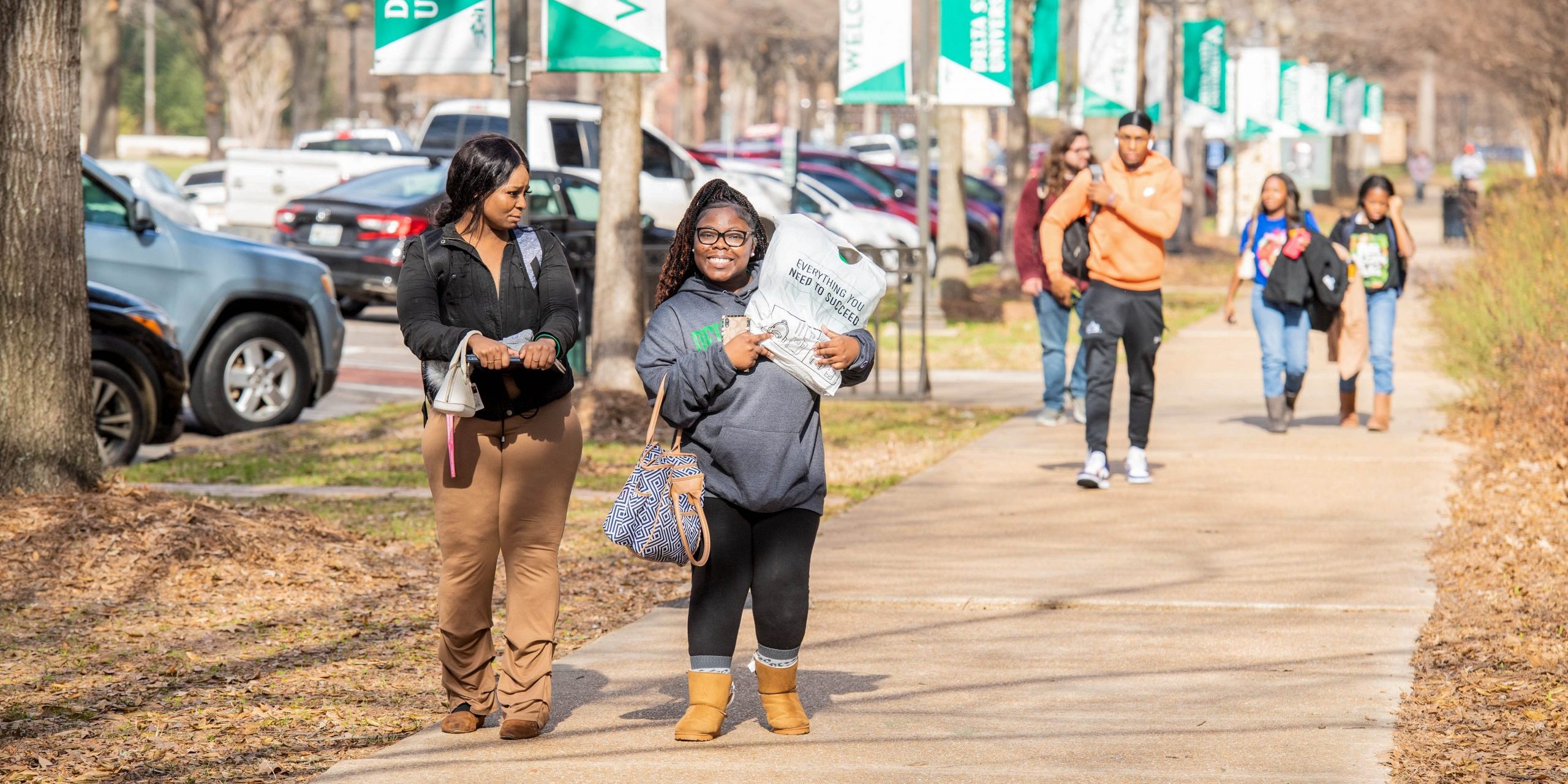 Freshmen students walking to call on the first day of school with books and backpacks.