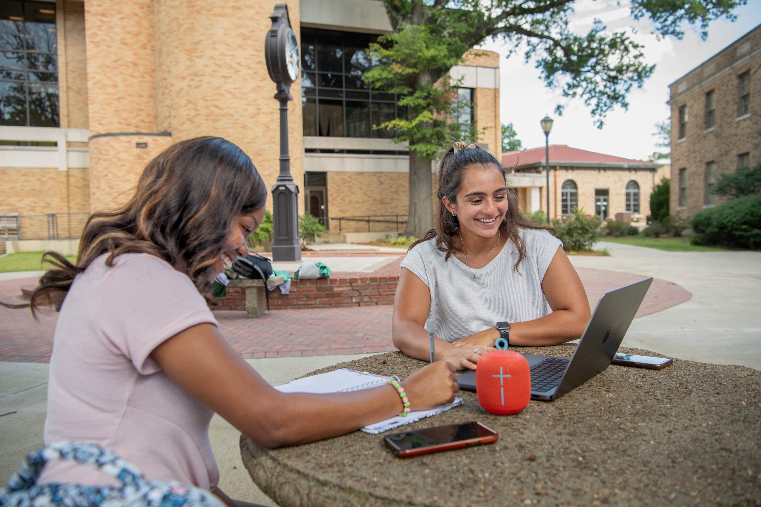 2 students looking at laptop for scholarship information.