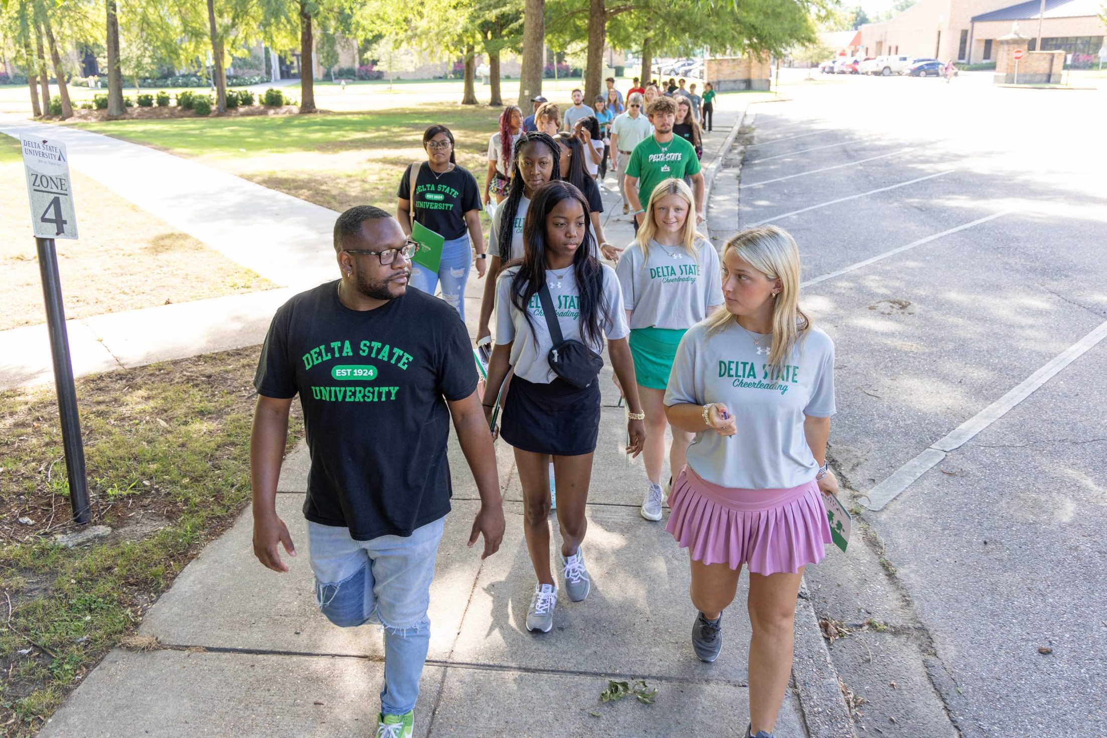 Prospective students touring the Delta State University campus with a guide.