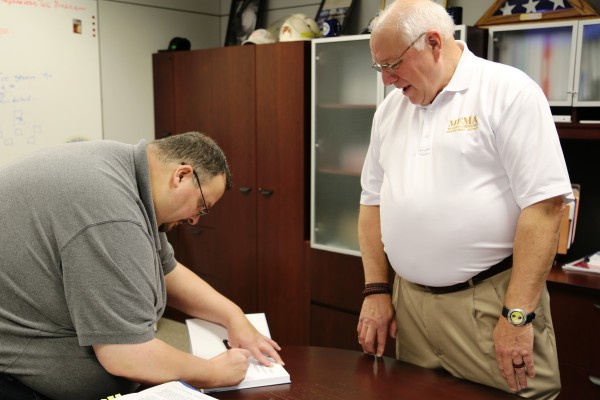 Talbot signing his book at MEMA