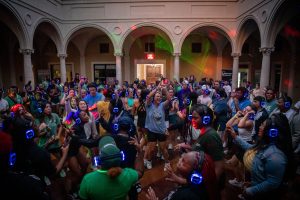 Large group of students dancing at silent disco student event.