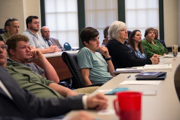 Students, faculty, and staff listen to an IBS speaker.