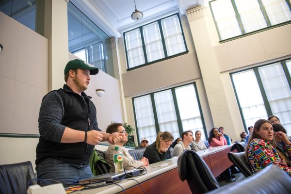 A student asks questions during the symposium.