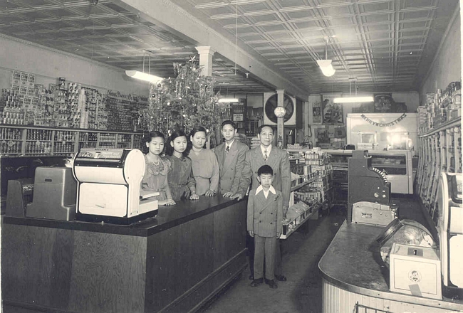 Family proprietors of general store, black and white.