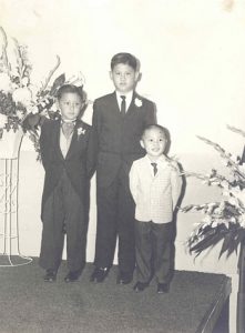 Portrait of three young boys attending a wedding. B&W.