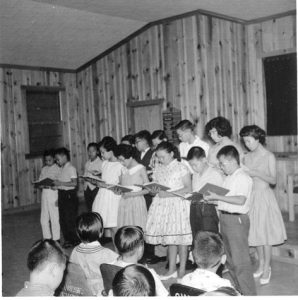 Children singing in choir, B&W.