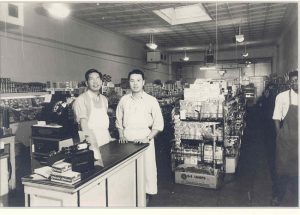 Men posing near counter.