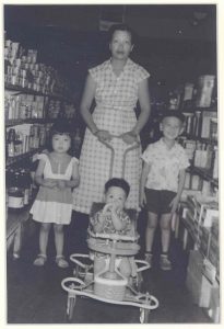 Mother with three children in store