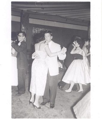 Man and woman dancing at social, B&W.