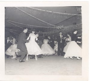 Young adults dancing at social event, B&W.
