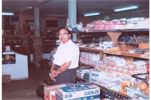 Color, man posed next to items.