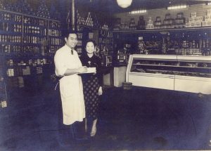 Husband and wife pose in their store.