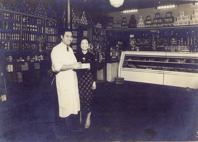 Husband and wife pose in their store.