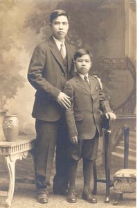 Man and child posing for portrait, B&W.