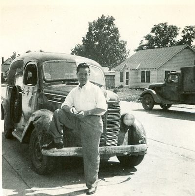 Man poses with pick-up. B&W.