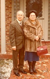 Portrait of couple in front of house, color.