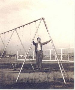 Man standing on swing, B&W.