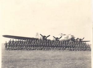 Military company in front of plane, B&W.