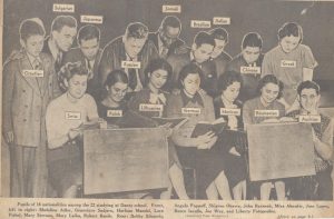 B&W photo from newspaper clipping of students holding signs.