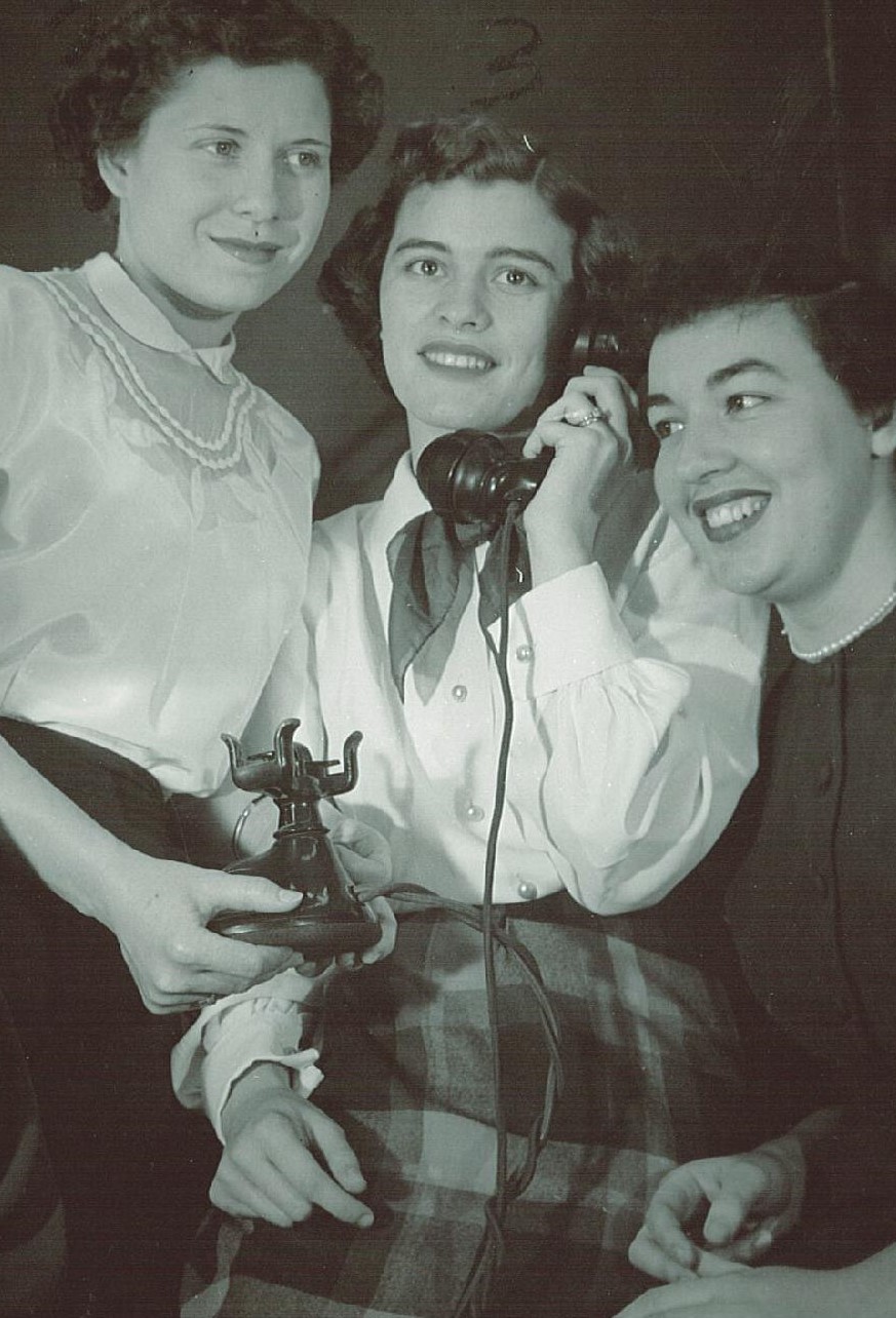 Women using ol;d fashion telephone