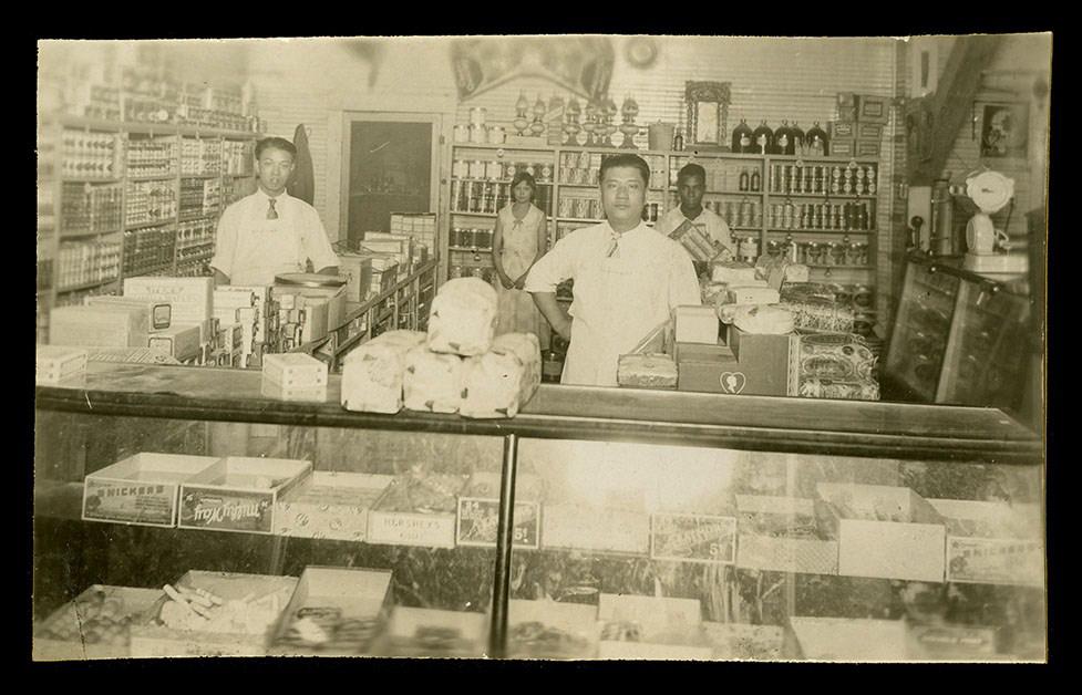 Four people stand behind a counter.